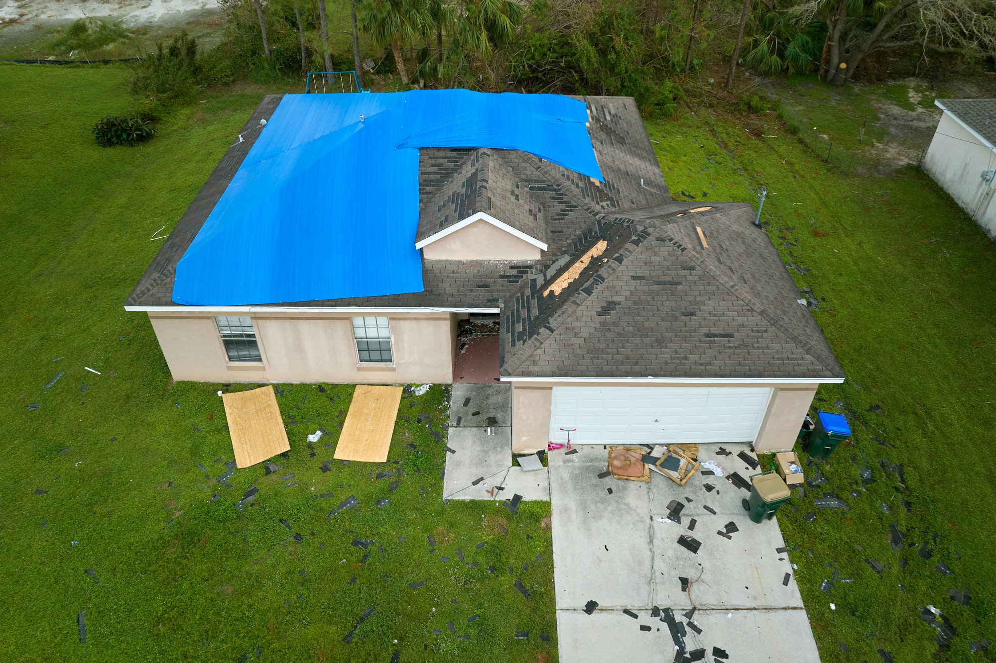 top-view-of-leaking-house-roof-covered-with-protec-2024-12-07-01-19-47-utc top-view-of-leaking-house-roof-covered-with-protec-2024-12-07-01-19-47-utc