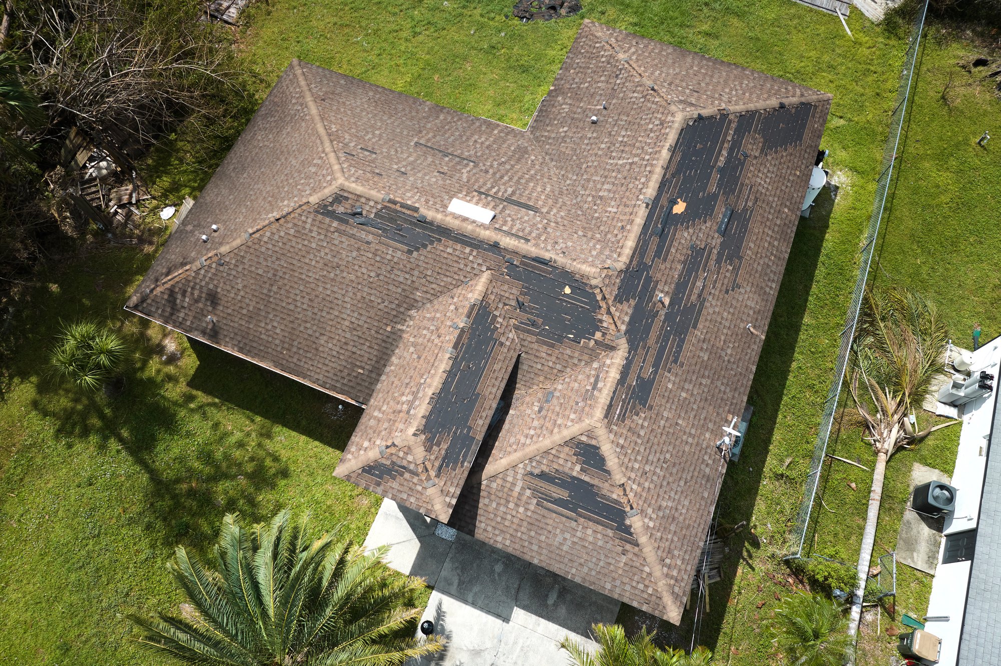 wind-damaged-house-roof-with-missing-asphalt-shing-2024-12-06-21-15-24-utc